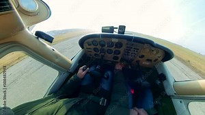 Male pilot takes off, driving a small plane.