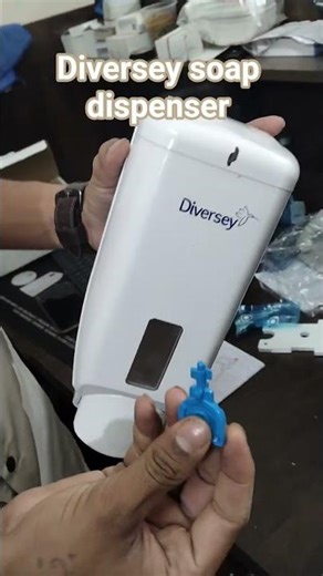 This is a Diversey (TASKI) manual liquid soap dispenser, a heavy-duty model bluepoint office solut