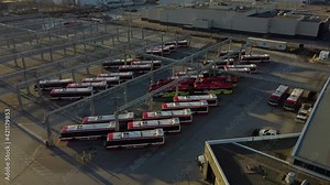 TTC public transit buses at large operations, maintenance and storage facility revealing empty parking spaces; aerial