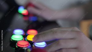 Teenage girl using arcade machine close up