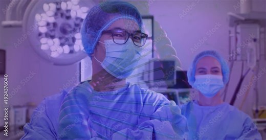 Blue DNA helix fading in urging surgeon rotating into view under operating light colleague watching