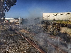 Fire Along Railroad Tracks Doused Before Spreading To Buildings