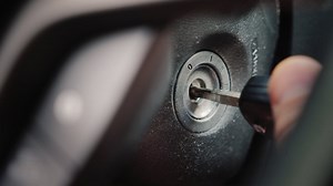 Premium stock video - The ignition key is inserted into the well and start the car engine close-up shot