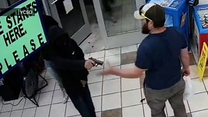 Surveillance video shows Marine veteran stop armed robbery