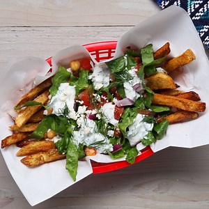 3M views · 16K reactions | These loaded fries are topped with your favorite Mediterranean toppings, from crunchy cucumbers and onion to creamy chickpeas and feta, brought together with a tangy, herby yogurt sauce. | Tasty | Facebook