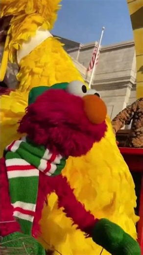 Elmo is waving at temple university diamond marching band at the Macys thanksgiving parade yesterday
