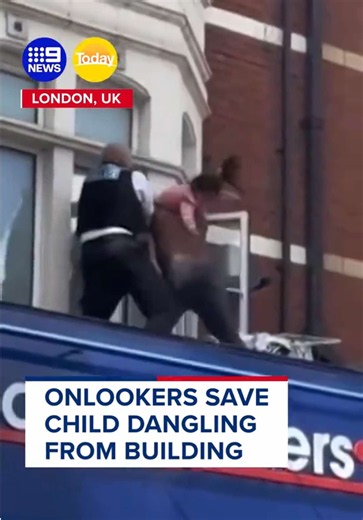 A toddler has been pulled to safety after being found hanging from a building ledge in London. #9News