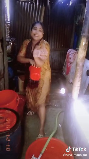 Traditional Water Fetching in Rustic Kitchen