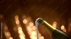 Champagne explosion. Sparkling wine popping, opening champagne bottle closeup. Sparkling wine over holiday blinking background. 4K UHD video footage. Slow motion 3840X2160