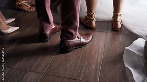 Male legs close-up. He approaches the bride. Classic shoes.