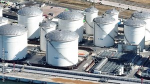 Petroleum oil storage silos. Refinery industrial oil tank container top down aerial drone view. Chemical liquid metal business storage container structure. Overhead view.