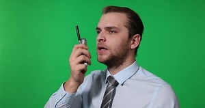 Attractive Business Man Walkie Talkie Communication in Green Screen Background