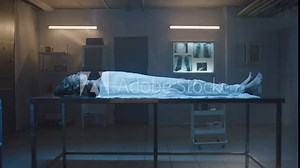 Side view of Covered body of a deceased woman on the table at the morgue