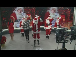Dancing Santas perform with FOX 2 Anchors