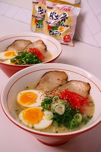 In Japan, marinated eggs, ajitsuke tamago, are an essential ramen topping, known for their umami-rich flavor and soft, jammy yolk. These eggs are traditionally marinated in a blend of soy sauce, mirin, and sake, allowing them to absorb deep, savory-sweet flavors while retaining their delicate texture. The marination process not only enhances taste but also preserves the eggs, making them a convenient addition to ramen, rice bowls, and bento lunches. Typically prepared in advance and left to soak