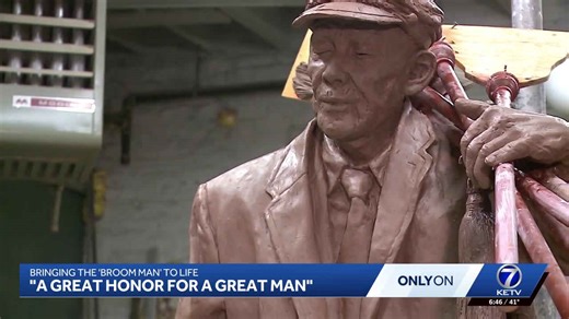 Sculptor creates bronze broom man