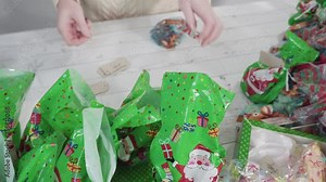 Step by step. Packaging homemade macadamia fudge into small gift bags.