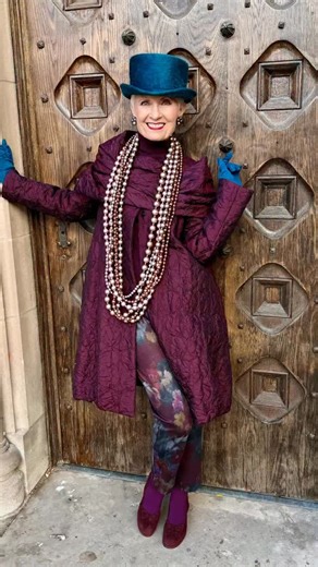 The infinity scarf which accompanies the plum colored coat by the indomitable @igor_fashionbrand provides endless entertainment. Draping the scarf four ways leads up to me kicking up my heels. I have a long way to go to attain my previous range of motion, but I’m determined to get there if at all humanly possible! Teal top hat from @eastvillagehats. Statement necklace by @jianhuilondon. Video and photos by @daniel_a_nolan #arttowear #over80 #styleover80 #tophat #advancedstyle | Style Crone