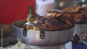 A genuine glimpse into a local kitchen in Cusco, Peru, where they prepare the traditional Chicharrón de Chancho with Peruvian corn known as choclo and sweet potatoes on the side.