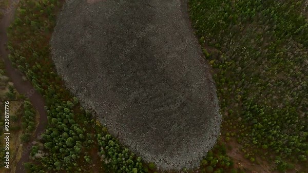 Top-down view over extinct lava flow reveals the crater rim and multiple cooled lava paths from Colima's Fire Volcano eruptions, Mexico