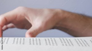 Reading book turning pages close-up 4K footage