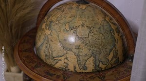 close up antique globe with old names history and geography of the earth beautiful brown globe antique map geography of the earth in the past countries on the map of an antique globe old map history