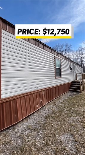 used mobile home priced at $12,750. The exterior shows normal age, but the home sits level with straight siding and intact windows. One skirting section near the side will need replacement. Inside, the flooring feels solid and the layout is simple but practical for everyday living. The living area offers enough room for basic furniture, while the kitchen includes older cabinets that still function properly along with working plumbing. The bedroom provides clean walls and solid flooring. The bath