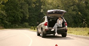 clip-1098879109-red-triangle-sign-behind-woman-near-broken