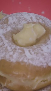 Spreading icing sugar on a donut with custard - Free Stock Video