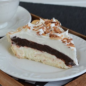 This Coconut Fudge Pie has layers of creamy chocolate & coconut goodness in every bite!!! This is such a delicious and easy dessert to make! Find the PRINTABLE RECIPE HERE: https://insidebrucrewlife.com/2014/03/coconut-fudge-pie/ | Inside BruCrew Life