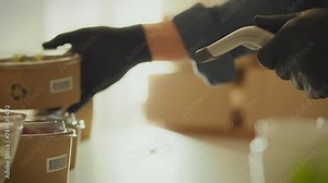 At a logistics warehouse, employees actively use laser scanners to scan barcodes on products, demonstrating an example of an effective and responsible approach to inventory management