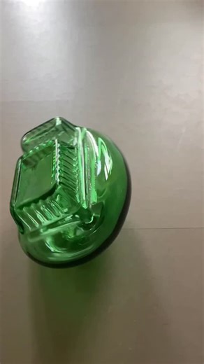 Nice bottle green single patatbakje glass object twisting around the floor | Hans Muller