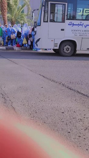 Women in Blue Hijabs Waiting for Medical Bus