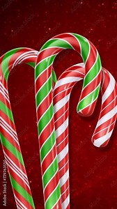 Vertical Candy Cane Dance with Snow on Red 4K Loop features candy canes dancing in front of a bright red background and swirling animated lines in particles in a vertical ratio loop.
