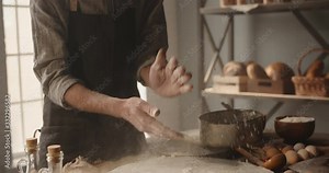 Experienced caucasian elderly man is starting to make pizza, applying flour to his hands. Senior pensioneer enjoying his hobby after retirement 4k footage