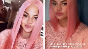 Chrissy Teigen looks radiant as she rocks pastel pink wig and cozy sweater