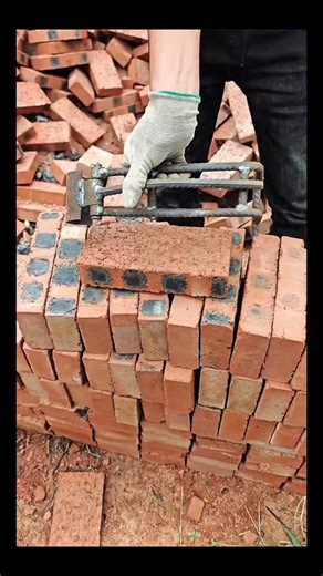 Real Engineerings | Engineering & Technology & Gadgets & DIY on Instagram: "Brick Lifting Genius: Simple Tool, Huge Impact! 🧱🛠️ ​Discover the brilliance of simple mechanical engineering! This custom-made Brick Carrier proves that you don't always need high-tech robots to improve efficiency on the construction site. ​The Physics of Friction ​This tool operates on a clever self-locking principle that uses the load's own weight to secure it: ​The Tool: A simple metal frame, likely welded from reb