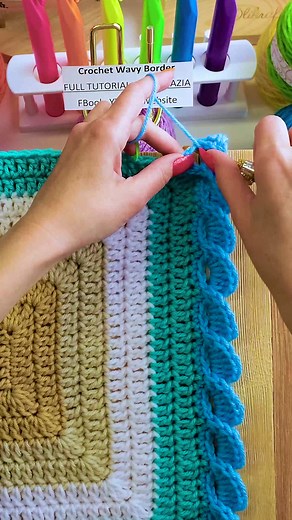 The crochet wavy border looks nice in most colors, especially those that remind you of the ocean. The stitch pattern consists primarily of double crochet stitches made over a chain four base. #reels #crochet #knitting #artist #ocean #waves #yarn #tutorial #makersgonnamake #naztazia | Naztazia