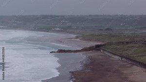 A 4k footage of a rough sea rolling in on St Ouen's Bay before a storm begins