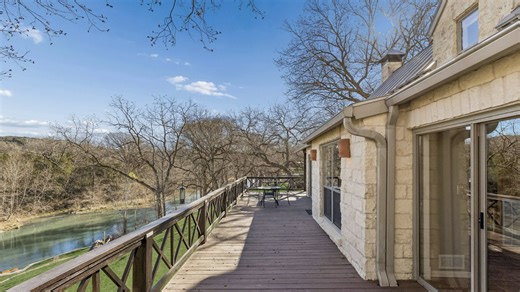 With 310’ of river frontage on 1.41 acres, this generational retreat delivers big water, big memories, and proven STR performance. A concrete dock with elevated patio, stone gathering pads, open-air cabin, and wraparound deck set the stage for long river days and unforgettable nights. Inside, it’s all character—vaulted beamed ceilings, Saltillo tile, river-view living spaces, and a main-level owner’s suite overlooking the water. Upstairs adds a vaulted bedroom and oversized bunk room with its ow