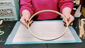 DIY Bicycle wheel wreath with just a few items! Items used: 12" round wooden hoop from Amazon Wooden dowels from Dollar Tree Hot glue Foam board Box cutter or exacto knife Waverly chalk paint Ink Floral of your choice Floral wire Zip ties | Windy City Crafts