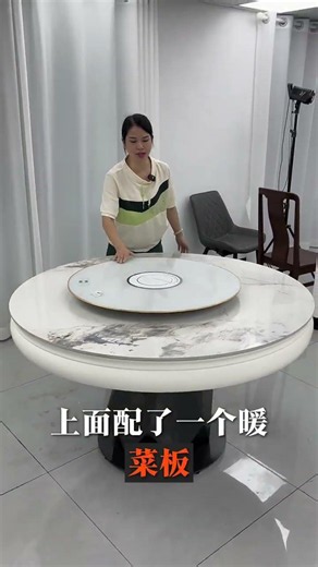 modern round dining table featuring a white marble-patterned surface and a built-in rotating center