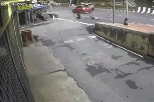 Red Mini Cooper hits motorbike in Bangkok, killing 1 and injuring another