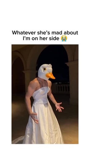 @epicvideosonig on Instagram: "This surreal video features a muscular "bride" in a duck mask violently rejecting a groom in a cinematic corridor, likely leading to a church. The dramatic shove suggests a final breakup just moments before the ceremony, subverting traditional wedding tropes by pairing bridal elegance with absurd headgear and physical aggression. #memes #fyp #viralvideos"