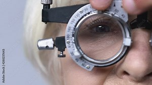 Ophthalmologist taking off lens from optical trial frame, glasses prescription