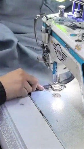 sewing the blue fabric precisely a professional electric metal sewing machine for textile production