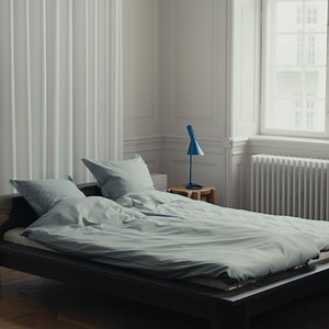 The smooth surface of damask woven bedding feels soft against the skin, while the tessellated pattern is calming on the eyes and mind. Facet bed linen in Mineral Green. | Georg Jensen Damask