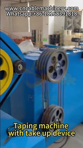 Taping machine with take up device