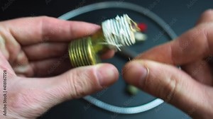 Plumber removing seal tape on a thread of a plumbing fitting