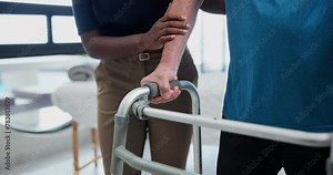 Rehab, walker and physiotherapist or patient, support and learning to walk with physical therapy. Senior man, recovery or healing with helping nurse, professional assistance with hand for old person